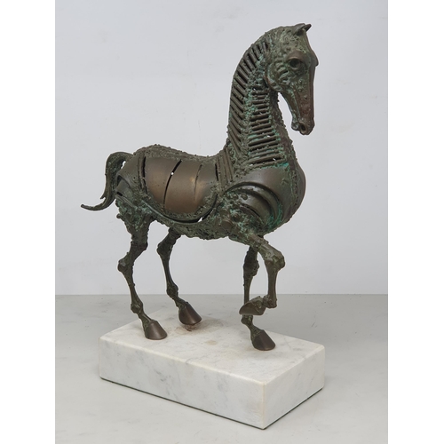 476 - WALENTY PYTEL. A patinated bronze Sculpture of a prancing horse, mounted on a white rectangular marb... 