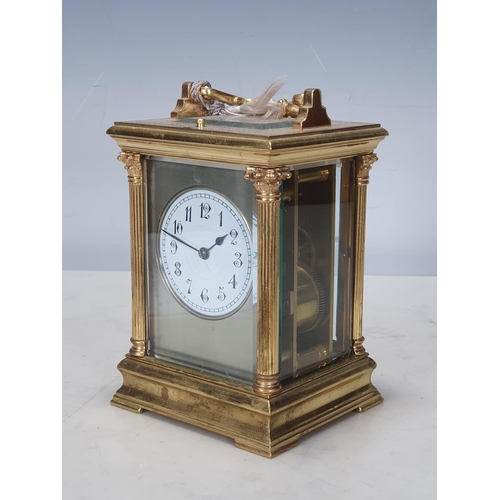 484 - A French brass cased Carriage Clock with moulded handle, Corinthian columns on moulded base, white e... 