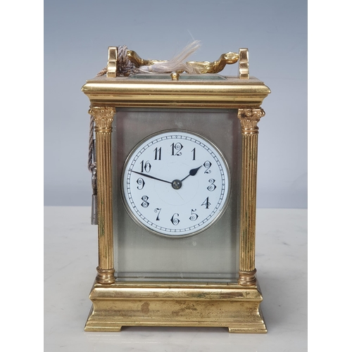 484 - A French brass cased Carriage Clock with moulded handle, Corinthian columns on moulded base, white e... 