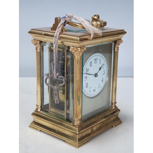 484 - A French brass cased Carriage Clock with moulded handle, Corinthian columns on moulded base, white e... 