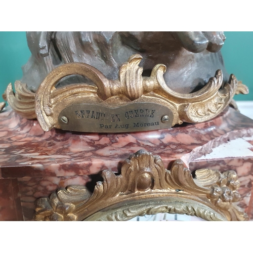 489 - A variegated red marble and gilt metal Clock Garniture, the clock having a large spelter winged cher... 