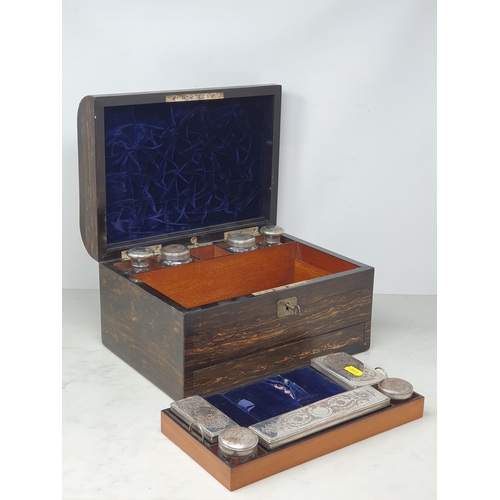 491 - A 19th Century coromandel Vanity Case and key, with hinged lid enclosing assorted silver plated lidd... 