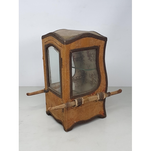 492 - An antique Doll's Sedan Chair fitted with two glass shelves as a Display Cabinet with gold fabric co... 