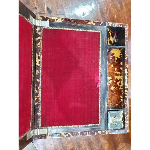 493 - A 19th Century tortoiseshell Writing Slope, the hinged lid enclosing red velvet writing surface, and... 