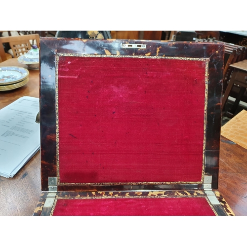 493 - A 19th Century tortoiseshell Writing Slope, the hinged lid enclosing red velvet writing surface, and... 