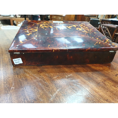 493 - A 19th Century tortoiseshell Writing Slope, the hinged lid enclosing red velvet writing surface, and... 