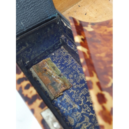 493 - A 19th Century tortoiseshell Writing Slope, the hinged lid enclosing red velvet writing surface, and... 