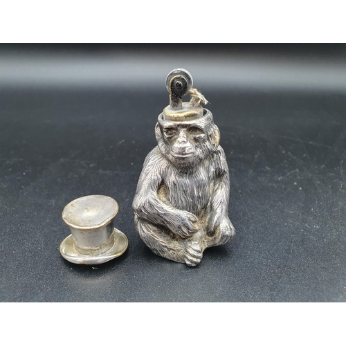 51 - A Continental plated Table Lighter in the form of a seated monkey wearing top hat, a Christening Spo... 