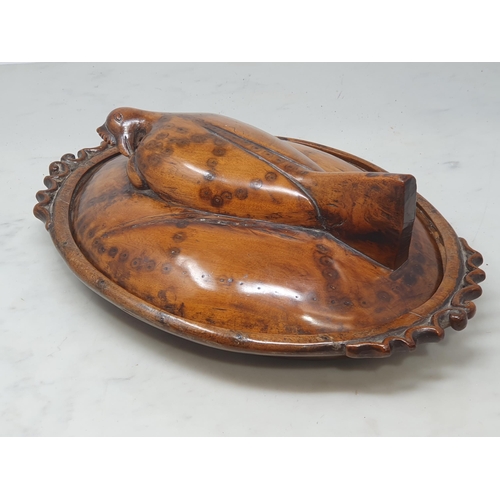 511 - A carved treen Hen Tureen, the lid handle in the form of a hen with pair of pierced scrolled handles... 