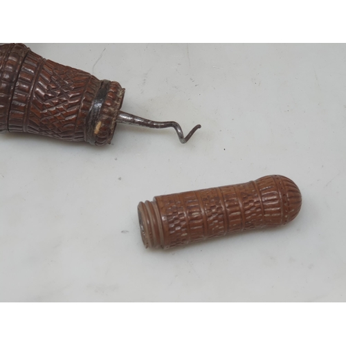 514 - Two carved coquila Nuts, a carved treen Case enclosing corkscrew A/F, and another turned nut lidded ... 