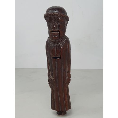 520 - An antique carved treen Nutcracker in the form of a Monk, 8 inches long