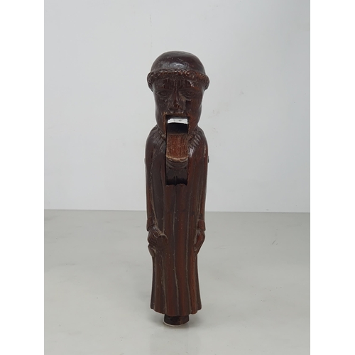 520 - An antique carved treen Nutcracker in the form of a Monk, 8 inches long