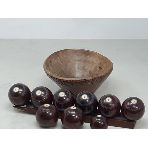 521 - A 19th Century set of Lignum Vitae Carpet Bowls of small size, eight bowls numbered 1-4 (two of each... 