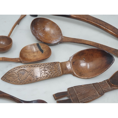 529 - A collection of treen Spoons including two Toddy Ladles, two Ladles, a carved and dated Love Spoon, ... 