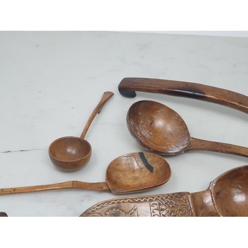 529 - A collection of treen Spoons including two Toddy Ladles, two Ladles, a carved and dated Love Spoon, ... 