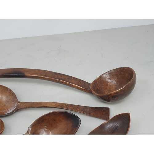 529 - A collection of treen Spoons including two Toddy Ladles, two Ladles, a carved and dated Love Spoon, ... 