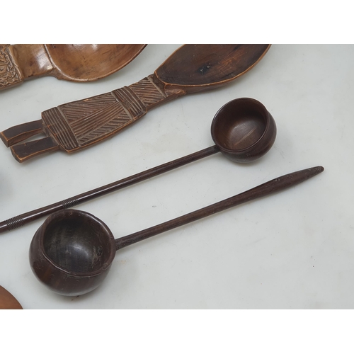 529 - A collection of treen Spoons including two Toddy Ladles, two Ladles, a carved and dated Love Spoon, ... 