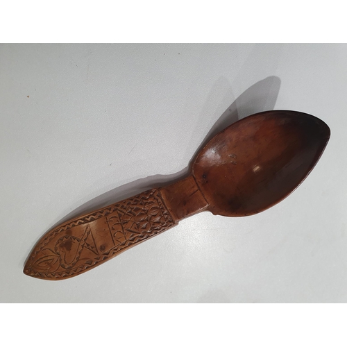 529 - A collection of treen Spoons including two Toddy Ladles, two Ladles, a carved and dated Love Spoon, ... 