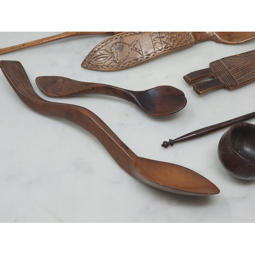 529 - A collection of treen Spoons including two Toddy Ladles, two Ladles, a carved and dated Love Spoon, ... 