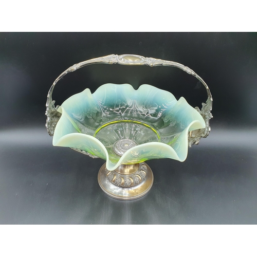 53 - A vaseline glass Bowl of shaped circular form on WMF plated stand with mask, fruiting vine and gadro... 