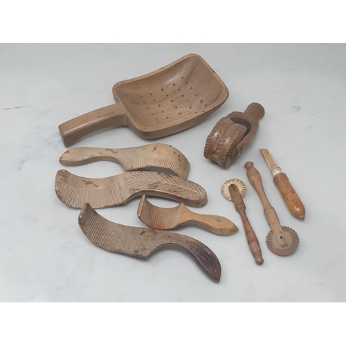 530 - A collection of treen items including a Butter Roller, four Butter Curlers, a Dairy Strainer and two... 