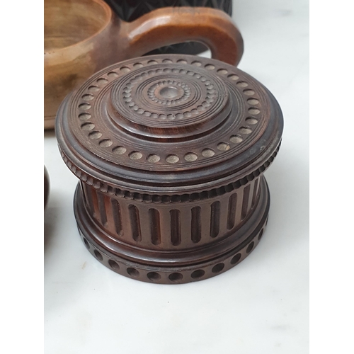 542 - A collection of treen including a pair of turned lignum vitae Dumbbells, a circular treen lidded Box... 