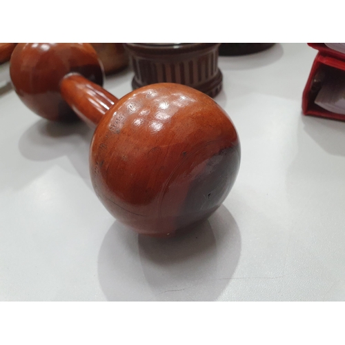 542 - A collection of treen including a pair of turned lignum vitae Dumbbells, a circular treen lidded Box... 