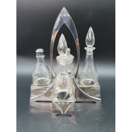 57 - An Arts & Crafts five bottle Cruet on plated stand with central handle, 9 1/2in, marked BM, 1/10