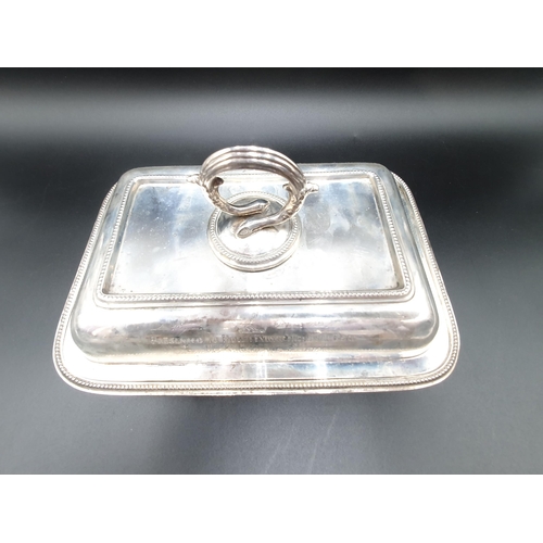 62 - An Edward VII silver oblong Entree Dish and Cover with presentation inscription, beaded rim and snak... 