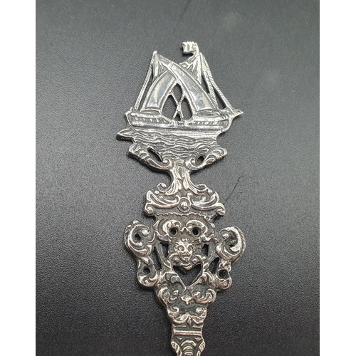 70 - A Dutch silver Spoon, the oval bowl decorated three figures including fiddler, sailing ship finial, ... 