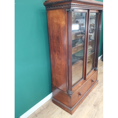 750 - A 19th Century rosewood glazed Display Cabinet with carved and moulded cornice, the doors flanked by... 