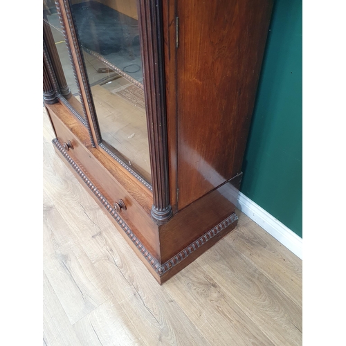 750 - A 19th Century rosewood glazed Display Cabinet with carved and moulded cornice, the doors flanked by... 