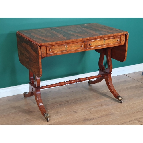 767 - A Regency style rosewood veneered and brass inlaid Sofa Table on lyre shaped end supports united by ... 