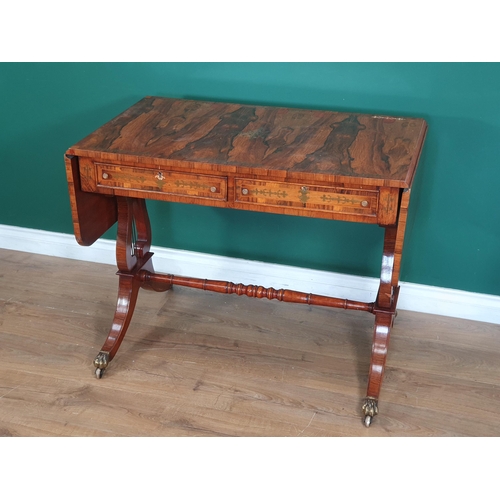 767 - A Regency style rosewood veneered and brass inlaid Sofa Table on lyre shaped end supports united by ... 