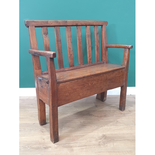 771 - An antique oak Box Settle with slat back rest on square supports, 2ft 9