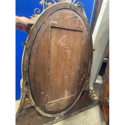 775 - A 19th Century gilt Overmantel Mirror with pierced and scrolled surmount above the oval plate surrou... 