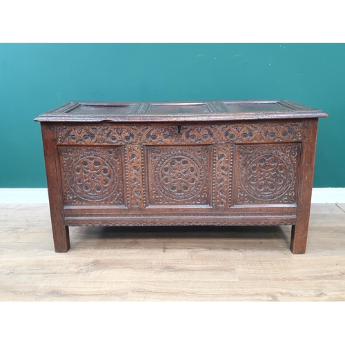 776 - A 17th Century oak West Country Coffer with sunken three panel lid above arcaded leafage shallow car... 