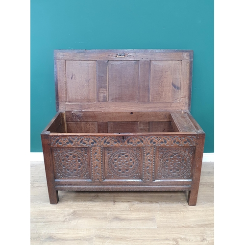 776 - A 17th Century oak West Country Coffer with sunken three panel lid above arcaded leafage shallow car... 