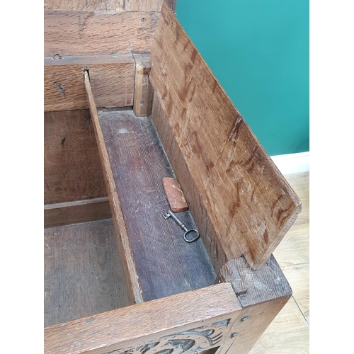 776 - A 17th Century oak West Country Coffer with sunken three panel lid above arcaded leafage shallow car... 