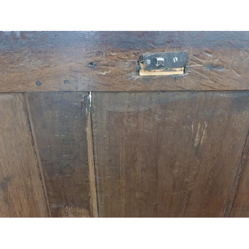 776 - A 17th Century oak West Country Coffer with sunken three panel lid above arcaded leafage shallow car... 