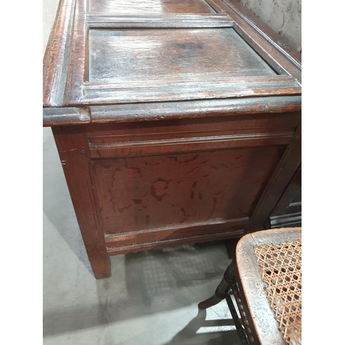 776 - A 17th Century oak West Country Coffer with sunken three panel lid above arcaded leafage shallow car... 