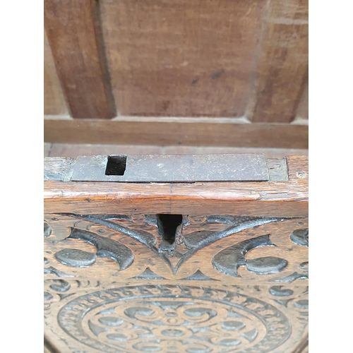 776 - A 17th Century oak West Country Coffer with sunken three panel lid above arcaded leafage shallow car... 