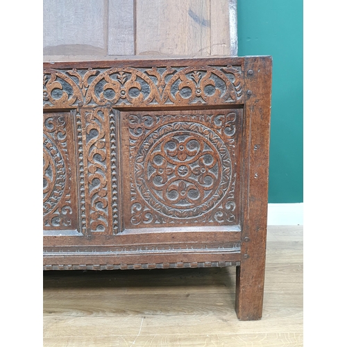 776 - A 17th Century oak West Country Coffer with sunken three panel lid above arcaded leafage shallow car... 