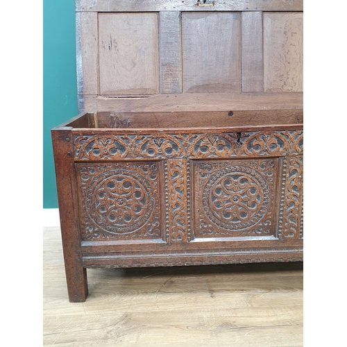 776 - A 17th Century oak West Country Coffer with sunken three panel lid above arcaded leafage shallow car... 