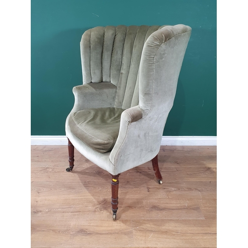 777 - A Regency barrel back Easy Chair with pale green upholstery on turned mahogany front legs and caster... 