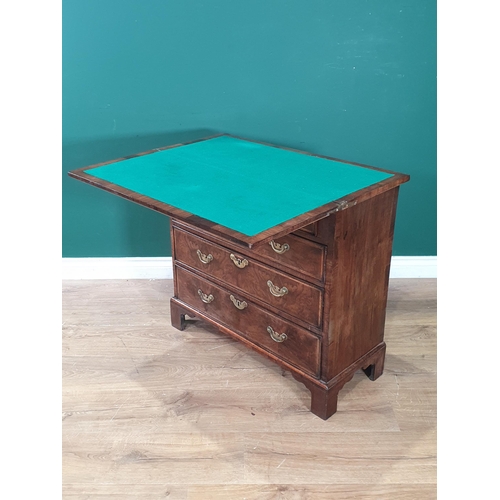 778 - An 18th Century walnut Bachelor's Chest, the feather banded top folding over to reveal a baize linin... 