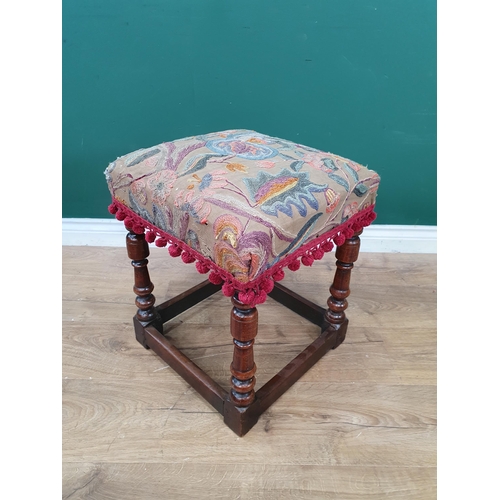 780 - An 18th Century walnut Stool with crewel work seat on turned supports and squared stretchers, 19in H... 