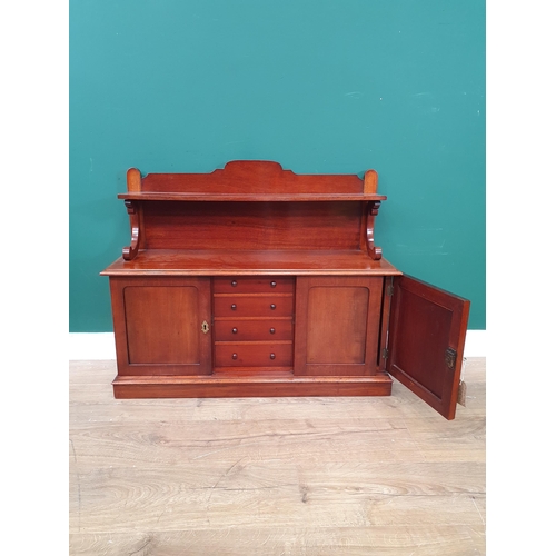 784 - A mahogany table-top Chiffonier, the raised back with scrolled supports above a pair of cupboard doo... 