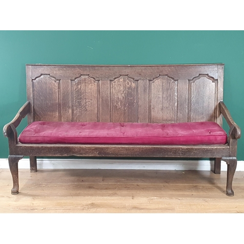 786 - An Antique oak five panel back Settle with shaped arms, button upholstered seat raised on cabriole s... 