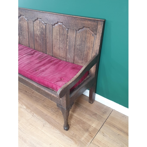 786 - An Antique oak five panel back Settle with shaped arms, button upholstered seat raised on cabriole s... 